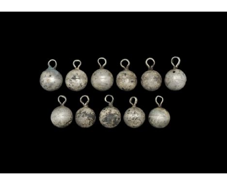 9th-12th century AD. A group of silver spherical pendants, probably from a woman's diadem, each with a D-section suspension l