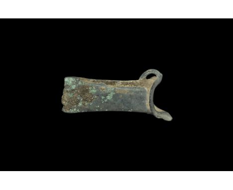 2nd millennium BC. A small bronze European axehead with scooped socket and flange to the mouth; the loop connected perpendicu
