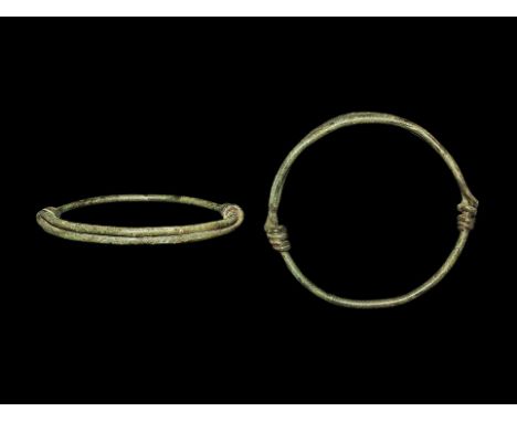 3rd century BC-1st century AD. A bronze round-section hoop with each end coiled around the shank.    22 grams, 78mm (3"). Pri