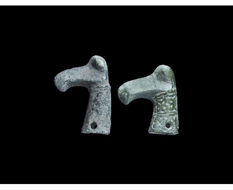 12th-13th century AD. A group of two staff terminals, each a slightly tapered tubular socket with scrolled tendrils and hatch