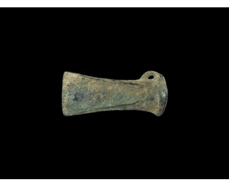 1300-1000 BC. A large European axehead with narrow bronze blade, straight edge and flared end; the socket with thick collar t