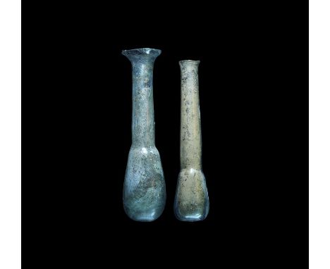 1st-2nd century AD. A pair of pale blue glass unguentaria, comprising: one with bulbous body, slender tubular neck and broad 