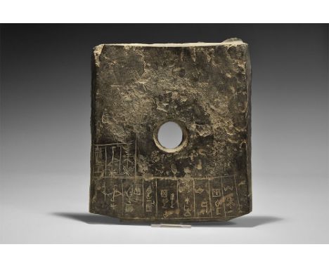 2700-2400 BC. A flat-section rectangular slate plaque with central hole, chamfered edges, incised text to the upper face; acc