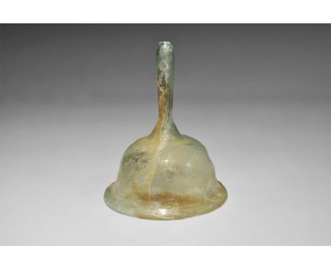 1st-2nd century AD. A pale blue-green iridescent glass funnel with bell-shaped bowl and drop-shaped hollow handle; everted ri