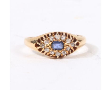 the central rectangular facet cut sapphire surrounded by a band of twelve rose cut diamonds within pierced claw settings, rin