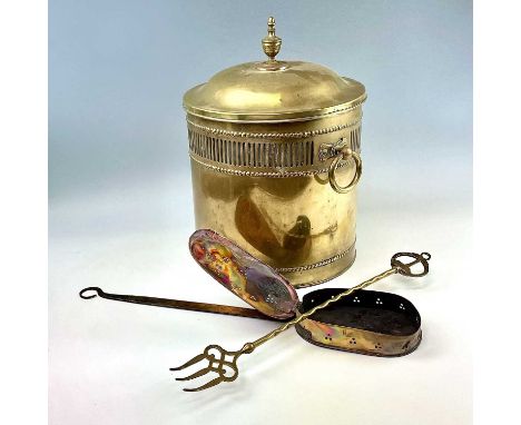 A cylindrical pierced brass coal box, early 20th century, the cover surmounted by as turned finial, with a pair of circular c