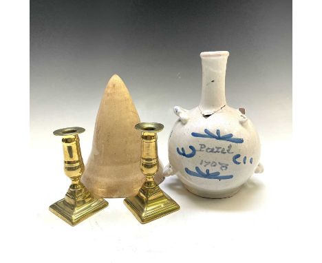 A blue and white pottery pilgrim flask inscribed and dated 1708, height 21cm, a pair of George III brass candlesticks, height