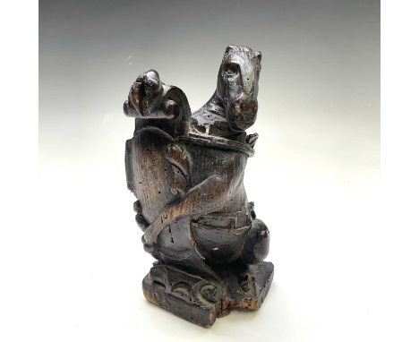 A carved wood finial in the form of a horse with a blank shield, possibly 17th century, height 20cm, width 11.3cm, depth 9cm.