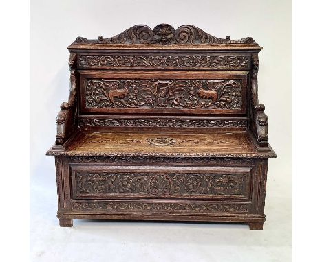 A Victorian carved oak hall bench, height 115cm, width 128cm, depth 48cm.Some movement of the back rail and one of the arms.