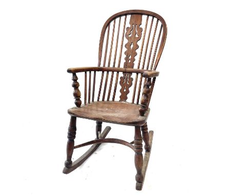 A 19th century ash and elm Windsor elbow chair with pierced vase splat, the ring turned legs over a crinoline stretcher and l