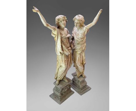 A pair of 17th century carved figures representing the seasons, possibly limewood, each in draped classical dress with one ar