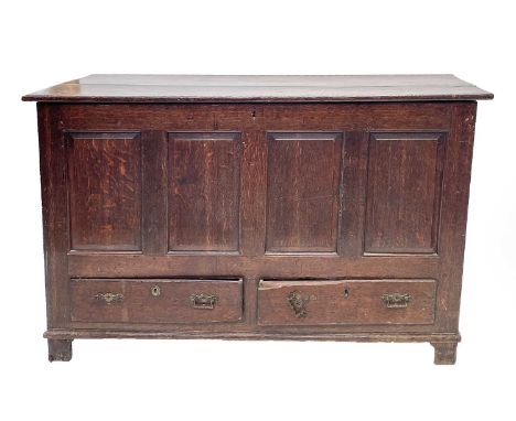 A George III oak mule chest, the rectangular hinged top above a quadruple panelled front and two drawers, on bracket feet, he
