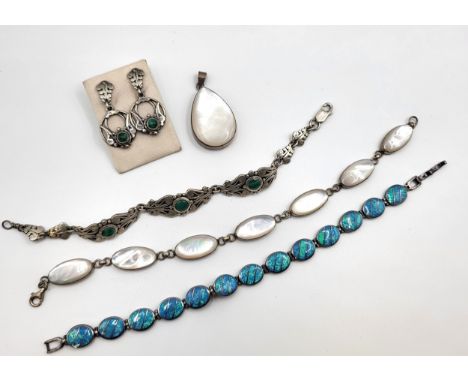 A collection of bracelets including mother of pearl set in silver with a matching pendant, a faux opal bracelet in silver,  a