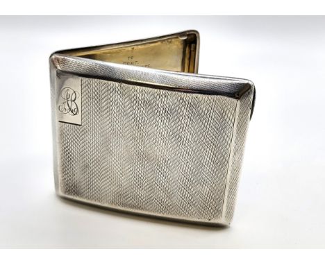 A silver curved engine turned cigarette case (gilded inside) with the initials AB inscribed on the front and 'To Bert with be