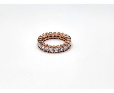 A rose gold-plated silver stamped S 925, princess cut cubic zirconia full eternity ring. 4.8gms Size M