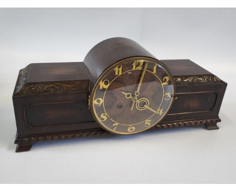 A 1940's Art Deco- style mantle clock with gold details. 21cm x 50cm.