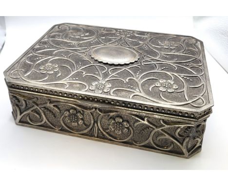 An arts and craft jewellery box with floral design, a burgundy baize interior with mixed sized compartments, a ring compartme