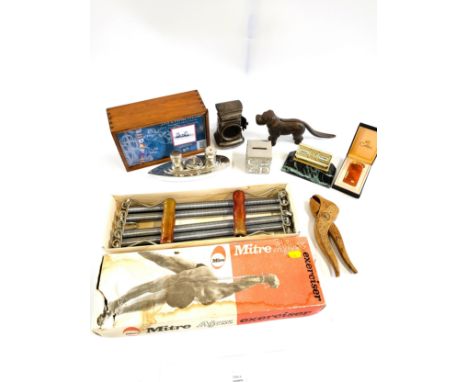 Two novelty nut crackers, a silver coloured money box in the shape of a cube, a Calibri lighter, condiments set in the shape 