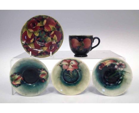 Moorcroft cup and four saucers  decorated with Pomegranate, leaves and berries and Freesia patterns, impressed and painted ma