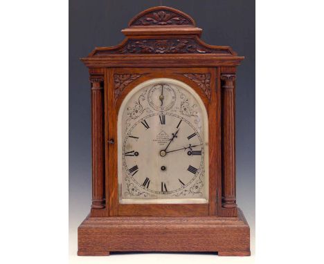 Large size oak bracket clock by Dent, London, circa 1900, the silvered arched dial with Roman chapters and slow/fast ring, in