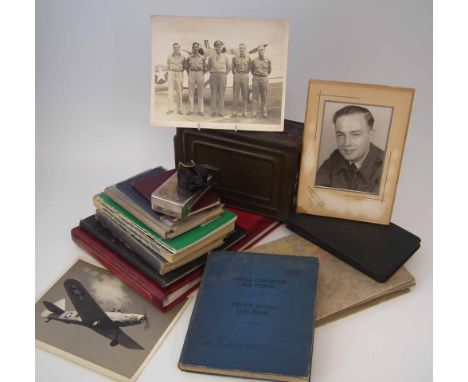Royal Air Force pilot's log book and related items for E.F. Steventon, the log is written in a Canadian log due to the wartim
