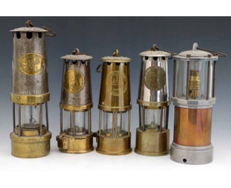 Two Protector Lamp & Lighting type 6  safety lamps, one with a flint wheel, the other with a later light bulb, height 25 & 25