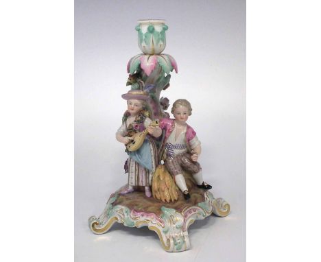 Meissen candlestick figure group  modelled with a girl playing a mandolin beside a seated boy on scrolled base, impressed mar