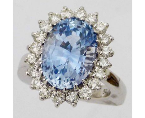 Oval sapphire and diamond cluster ring, the central pale stone approximately 9ct, on a white 750 shank marked Mauboussin, Par