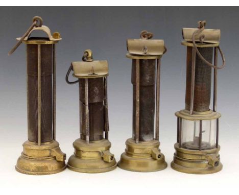 Three Newcastle type Davy safety lamps with exposed iron gauze sleeves and brass bodies, height 27, 24 & 21cm; also another s