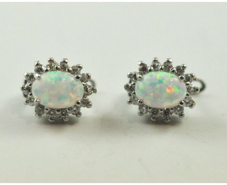 A pair of opal and cubic zirconia cluster stud earrings in Sterling Silver. Height 1.1cm / 0.45".