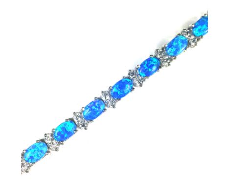 An opal and white stone bracelet in Sterling Silver formed of twenty oval cabochon opals, interspersed with pairs of round cu