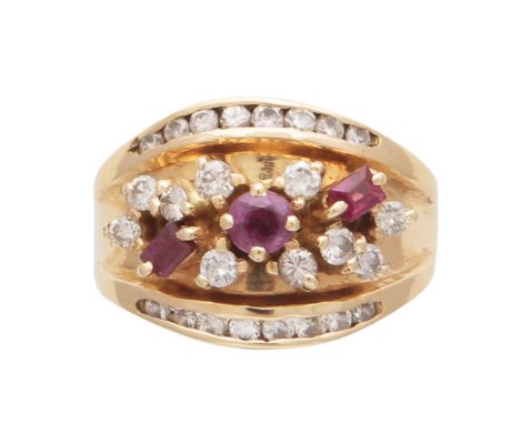 An antique ruby and diamond dress ring in 18ct yellow gold set with a one round and two rectangular step cut rubies in a flor