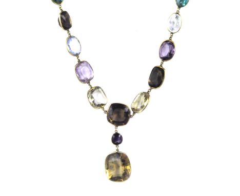 An antique late 19th Century gem set riviera necklace in yellow gold the chain set with eleven graduated oval and cushion cut
