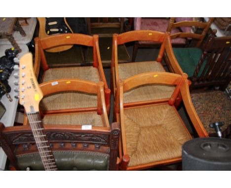 A set of four rush and string seated chairs and a pine ladder back dining chair
