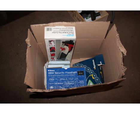 A box containing a security flood light; a tile cutter; bearing puller etc.