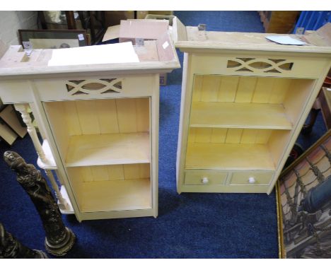 Two cream painted wall mounting shelf units.