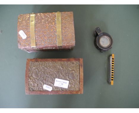 Two small metal caskets, harmonica, military compass.