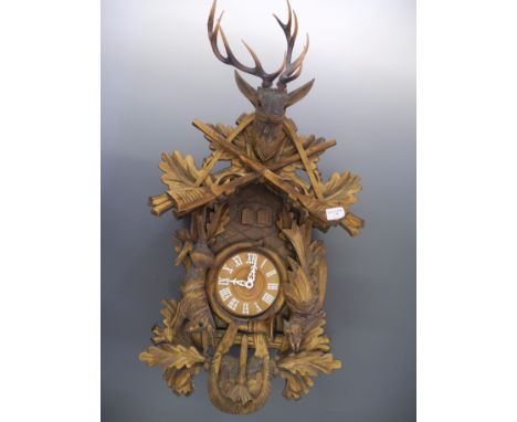A Black Forest style carved wooden Cuckoo clock.