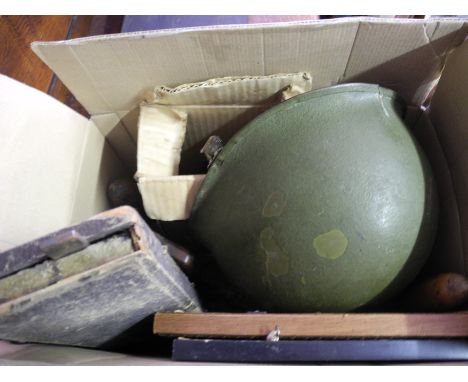 Box of assorted items, tools, blow torches, army helmet.