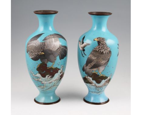 A pair of 19th Century Japanese enamel vases with falcon designs with waves and bird design, all on pale blue background.