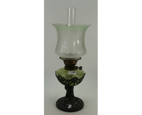Vaseline twirled glass oil lamp with cast iron base in the art nouveau style with matching shade and chimney 