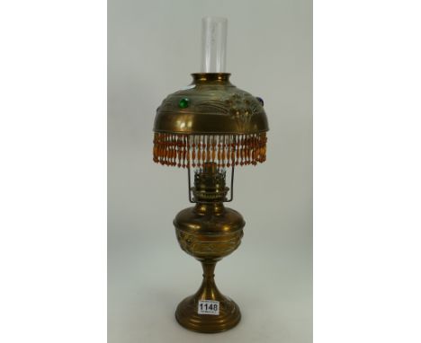 Embossed brass oil lamp with jeweled decoration to shade