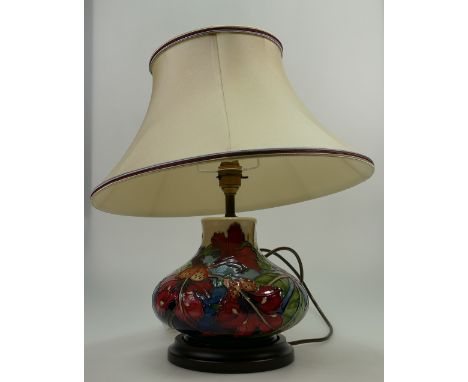 A Moorcroft lamp with wooden base and shade.  Decorated with Ovoid design.  40cm High.