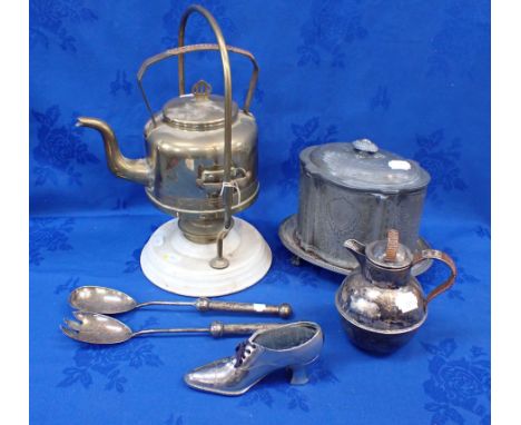 AN EDWARDIAN SPIRIT KETTLE ON BRASS AND CERAMIC STAND a plated biscuit box, silver-plated salad severs, Guernsey jug and a sh