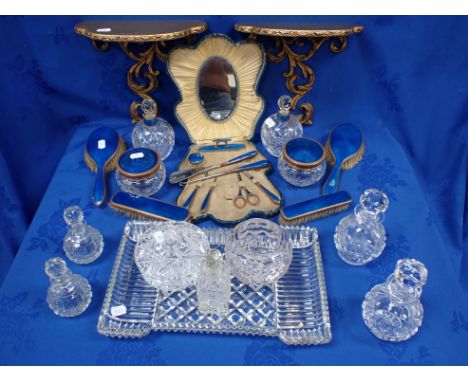 A PAIR OF GILT WALL BRACKETS, ENAMELLED DRESSING TABLE ACCESSORIES glass perfume bottles, and other items (wear, damage to en