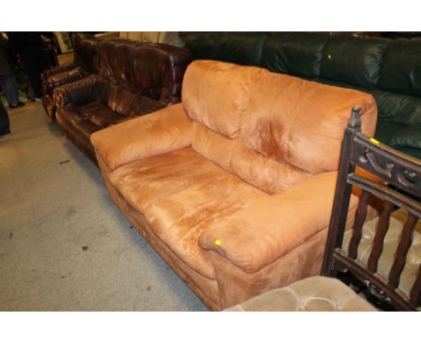 A TAN SUEDE TWO SEATER SOFA