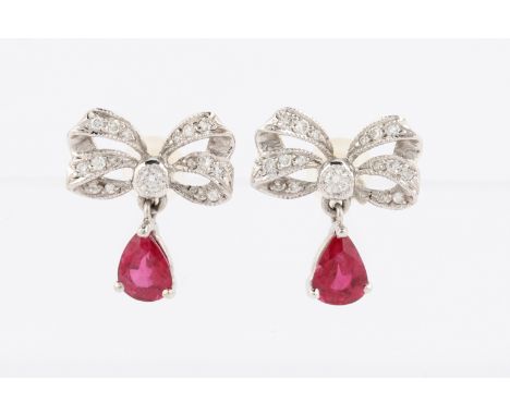 A pair of 18ct white gold ruby and diamond bow design earrings, the bow motif set with round brilliant cut diamonds and featu