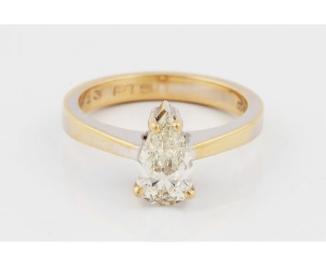 A diamond solitaire ring, claw set with a pear cut diamond, approx. 1.10ct, with raised shoulders, stamped 750, ring size M½,