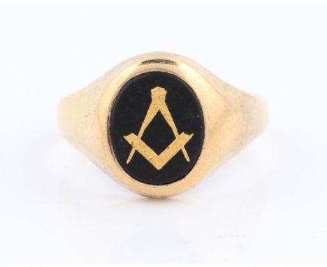 A 9ct yellow gold Masonic ring, set with a central oval black hardstone inlaid with compass and set square design, hallmarked