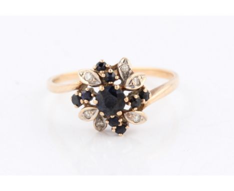 A 9ct yellow gold sapphire flower design ring, hallmark rubbed, ring size M½, weight approx. 1.8g.